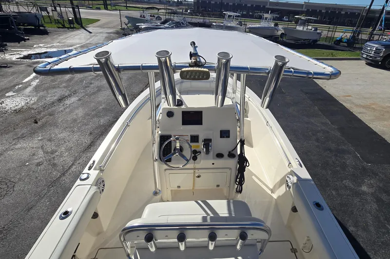Slide: The Image of 2022 Cobia 237 Center Console boat with T-top and helm station, docked outdoors. - 17