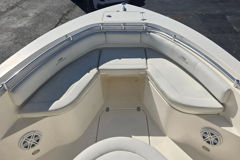 Slide: The Image of 2022 Cobia 237 Center Console boat with cushioned seating and stainless steel railings. - 19