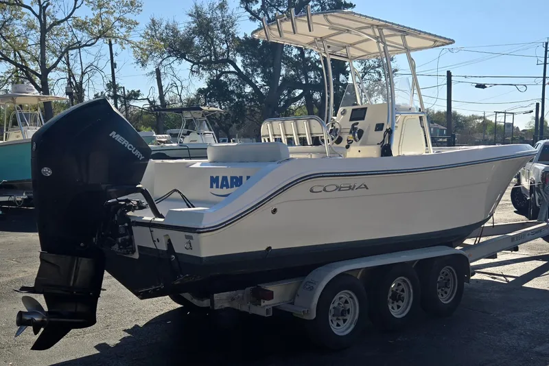 Slide: The Image of 2022 Cobia 237 Center Console boat on trailer with Mercury outboard engine. - 3