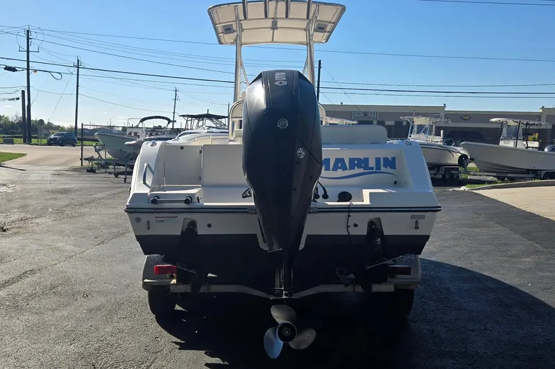 Slide: The Image of 2022 Cobia 237 Center Console boat with outboard motor, parked outdoors. - 4