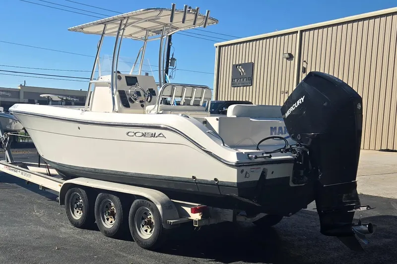 Slide: The Image of 2022 Cobia 237 Center Console boat on trailer with Mercury outboard motor. - 6