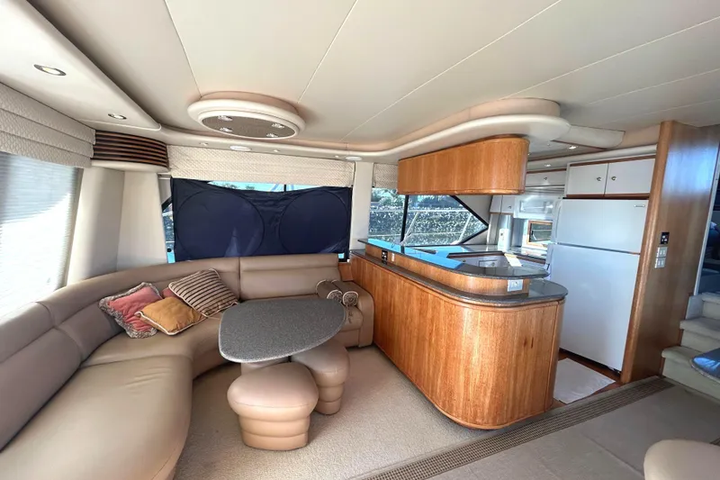 Slide: The Image of Luxurious interior of 1998 Bayliner 5788 Pilot House Motoryacht with plush seating and scenic window view. - 10