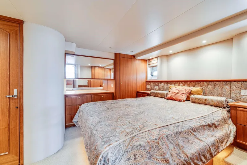Slide: The Image of Luxurious bedroom interior of 1998 Bayliner 5788 Pilot House Motoryacht with elegant wood finishes. - 101