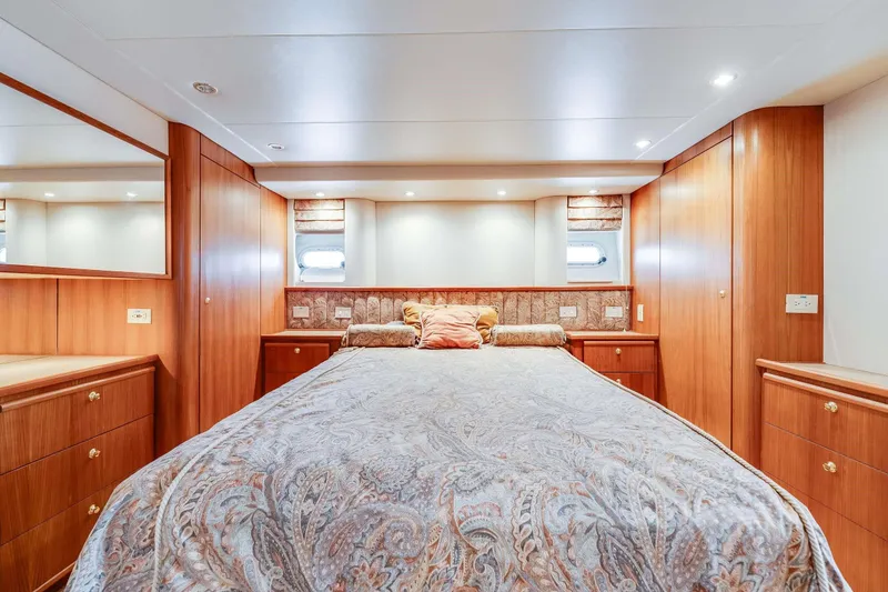 Slide: The Image of Luxurious bedroom interior of 1998 Bayliner 5788 Pilot House Motoryacht with wood paneling. - 102
