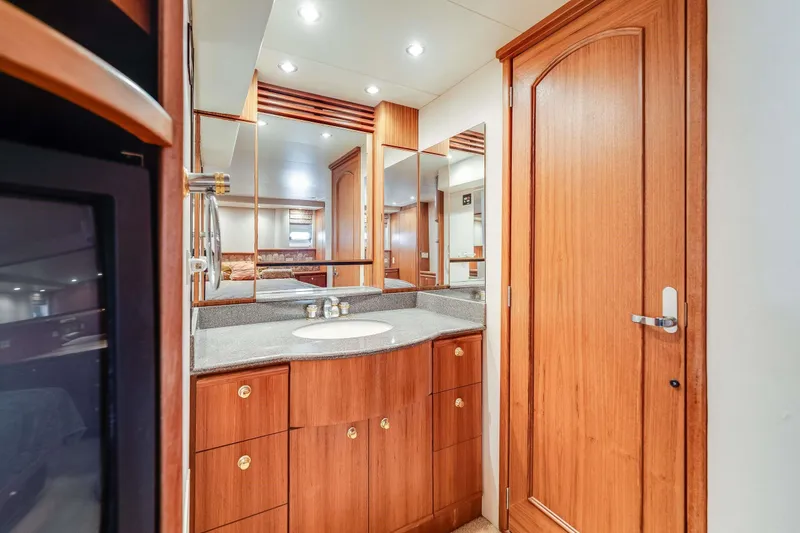 Slide: The Image of Luxurious bathroom interior of 1998 Bayliner 5788 Pilot House Motoryacht with wooden cabinetry. - 103