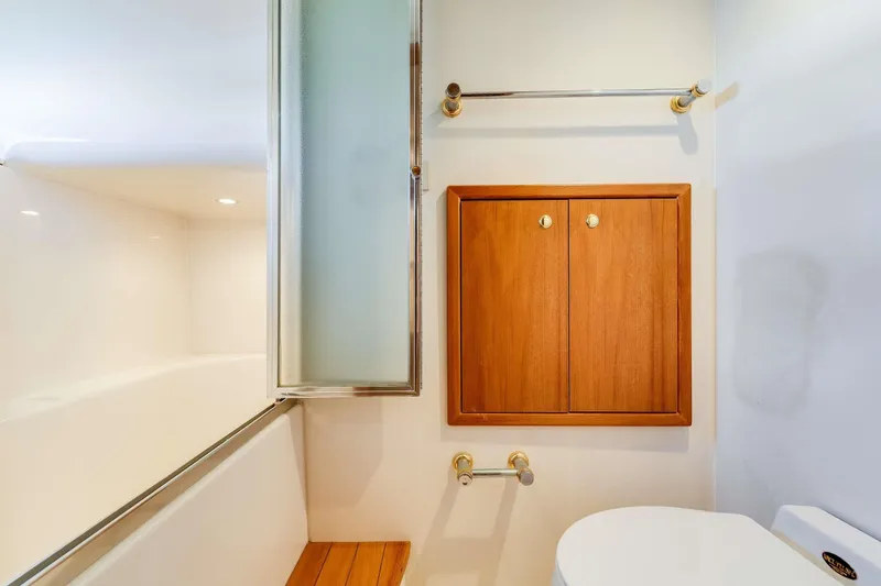 Slide: The Image of Bathroom interior of 1998 Bayliner 5788 Pilot House Motoryacht with wooden cabinet and shower. - 105
