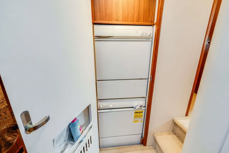 Slide: The Image of Laundry area in 1998 Bayliner 5788 Pilot House Motoryacht with stacked washer and dryer. - 106