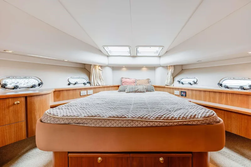 Slide: The Image of Luxurious cabin interior of 1998 Bayliner 5788 Pilot House Motoryacht with cozy bed and portholes. - 107