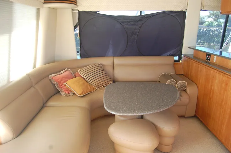 Slide: The Image of Luxurious interior of 1998 Bayliner 5788 Pilot House Motoryacht with elegant wood finishes. - 11