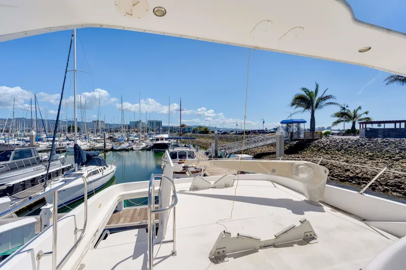 Slide: The Image of 1998 Bayliner 5788 Pilot House Motoryacht docked in a sunny marina. - 112