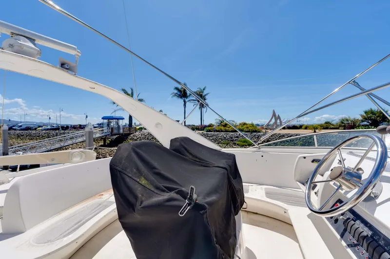Slide: The Image of 1998 Bayliner 5788 Pilot House Motoryacht helm with scenic marina view. - 115