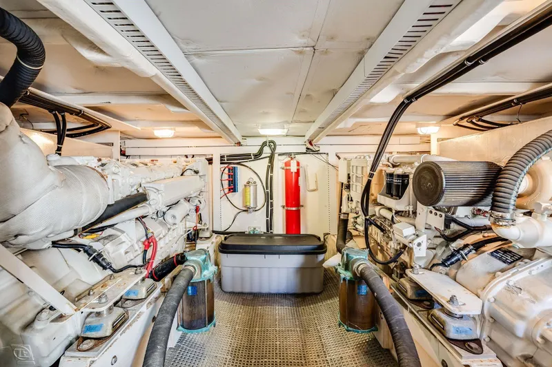 Slide: The Image of Engine room of 1998 Bayliner 5788 Pilot House Motoryacht, showcasing dual engines and equipment. - 116