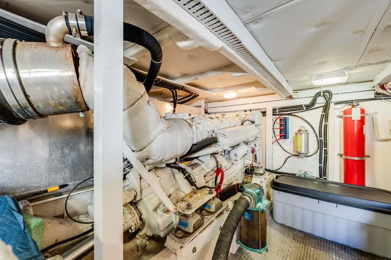 Slide: The Image of Engine room of 1998 Bayliner 5788 Pilot House Motoryacht, featuring machinery and safety equipment. - 118