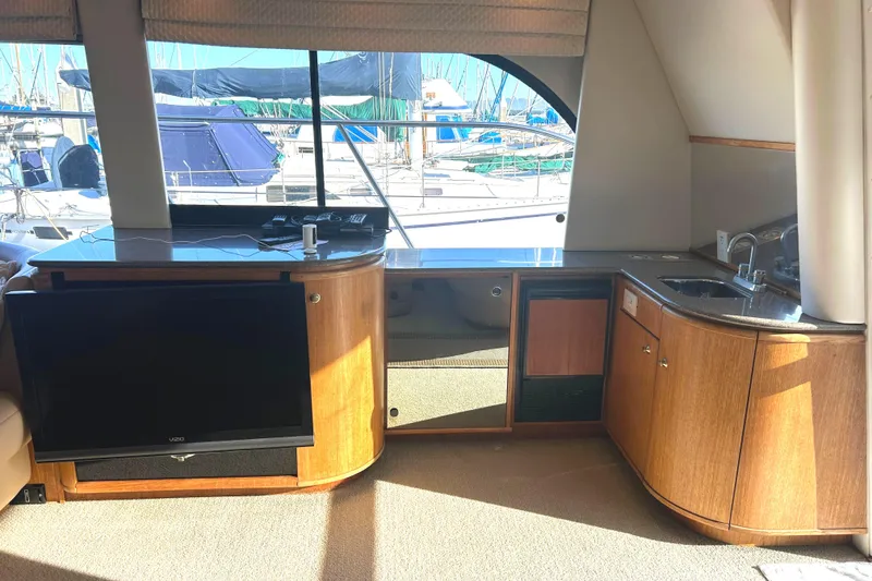 Slide: The Image of Interior of 1998 Bayliner 5788 Pilot House Motoryacht with TV and kitchenette. - 13