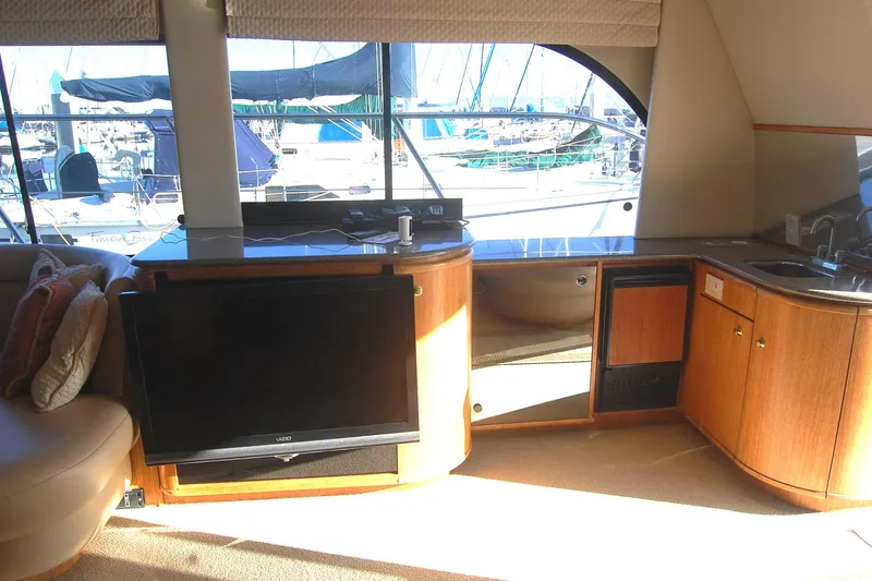 Slide: The Image of 1998 Bayliner 5788 Pilot House Motoryacht interior with TV and seating area. - 14