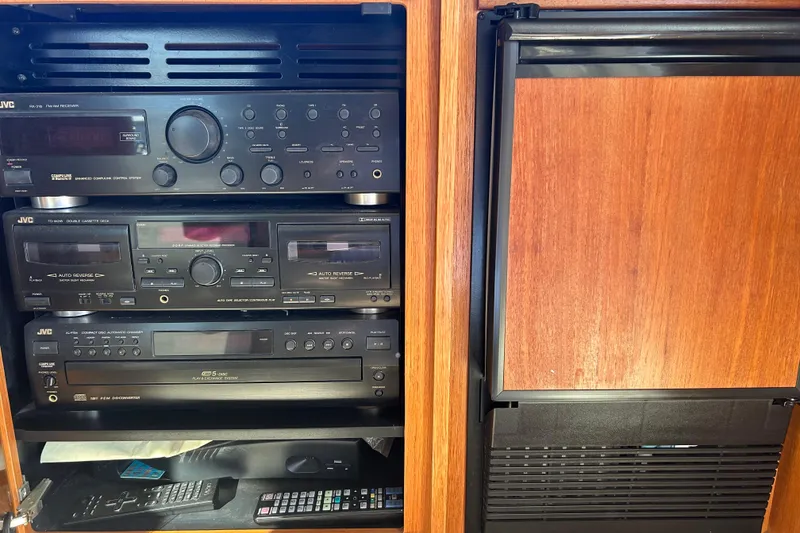 Slide: The Image of 1998 Bayliner 5788 Pilot House Motoryacht kitchen with sink, fridge, and wooden cabinetry. - 16