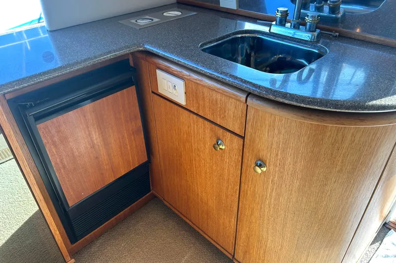 Slide: The Image of 1998 Bayliner 5788 Pilot House Motoryacht interior with curved seating and table. - 17