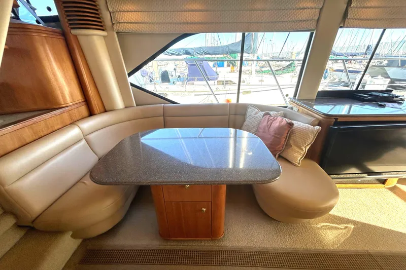 Slide: The Image of Luxurious interior of 1998 Bayliner 5788 Pilot House Motoryacht with plush dinnette - 18