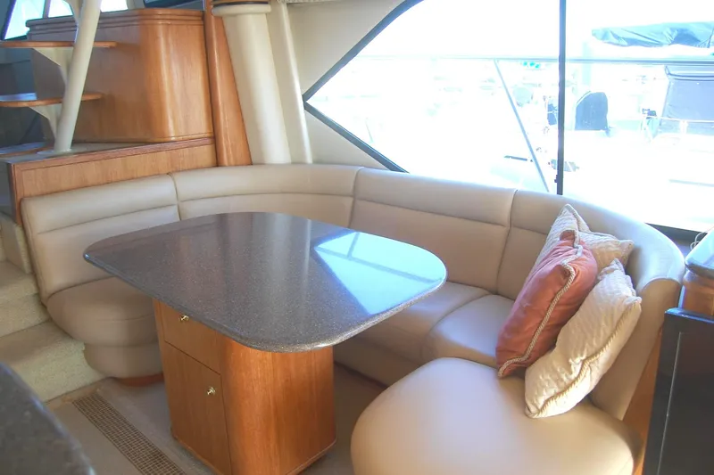 Slide: The Image of Luxurious interior of 1998 Bayliner 5788 Pilot House Motoryacht with elegant seating and table. - 19