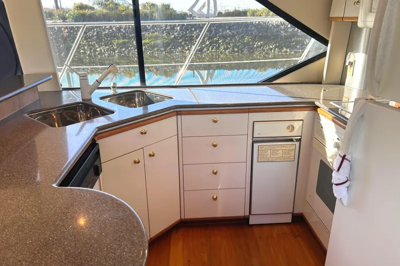 Slide: The Image of Luxurious kitchen area in 1998 Bayliner 5788 Pilot House Motoryacht with modern amenities. - 23