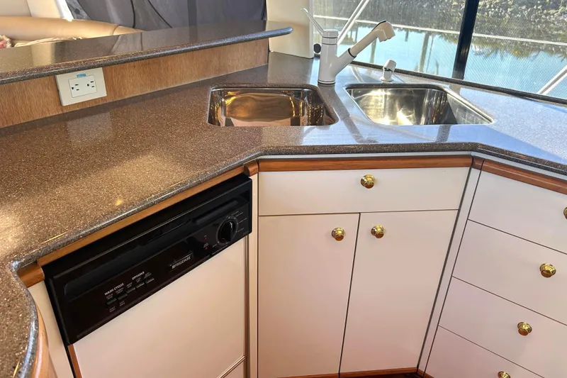 Slide: The Image of Galley area in a 1998 Bayliner 5788 Pilot House Motoryacht with full size appliances and countertops. - 24