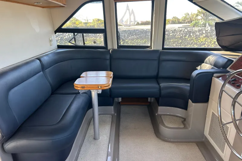 Slide: The Image of 1998 Bayliner 5788 Pilot House Motoryacht interior with helm, seating, and navigation equipment. - 28
