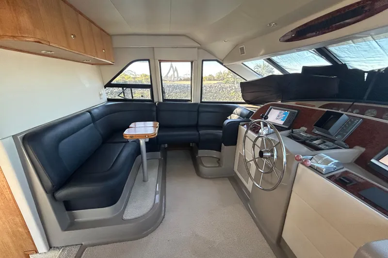 Slide: The Image of Interior of 1998 Bayliner 5788 Pilot House Motoryacht with modern staircase and seating area. - 29
