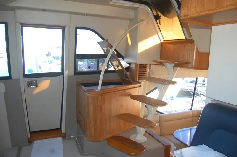 Slide: The Image of 1998 Bayliner 5788 Pilot House Motoryacht helm with steering wheel and navigation screens. - 30