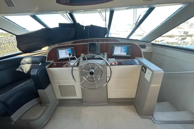 Slide: The Image of 1998 Bayliner 5788 Pilot House Motoryacht helm with Garmin navigation displays and steering wheel. - 31