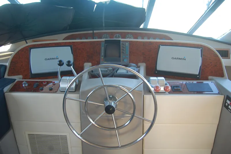 Slide: The Image of 1998 Bayliner 5788 Pilot House Motoryacht helm with dual screens and steering wheel. - 32