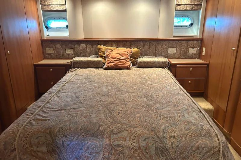 Slide: The Image of Luxurious bedroom in 1998 Bayliner 5788 Pilot House Motoryacht with elegant wood finishes. - 44