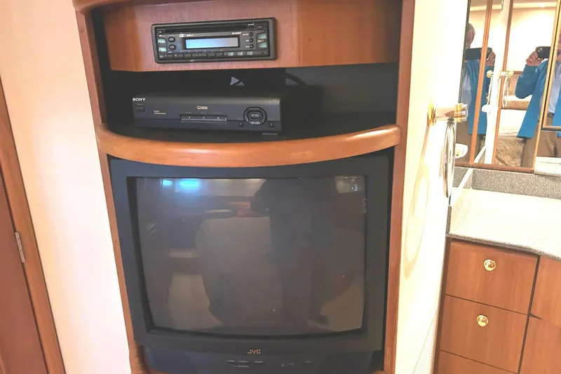 Slide: The Image of 1998 Bayliner 5788 yacht interior with vintage JVC TV and Sony DVD player. - 46
