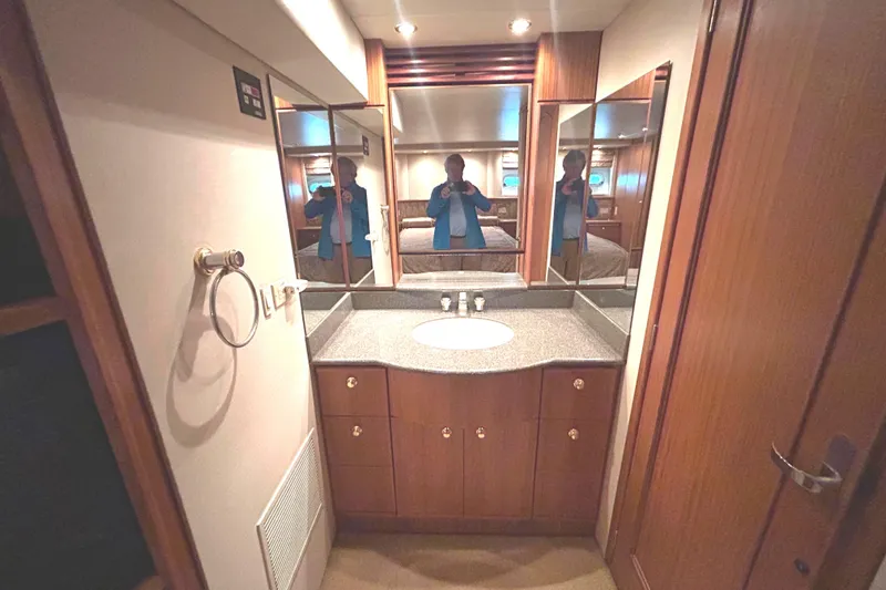 Slide: The Image of Head interior of 1998 Bayliner 5788 Pilot House Motoryacht with tub/shower and wooden cabinet. - 51