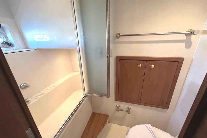 Slide: The Image of Interior view of 1998 Bayliner 5788 Pilot House Motoryacht bedroom with cozy bedding. - 54