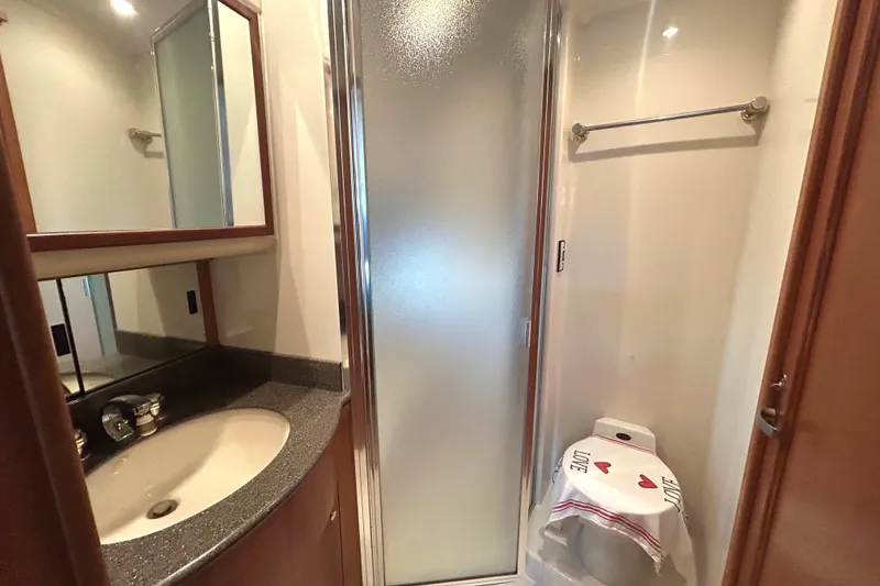 Slide: The Image of 1998 Bayliner 5788 Pilot House Motoryacht cabin with bunk beds and wooden cabinetry. - 64