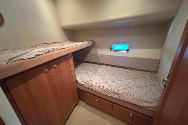 Slide: The Image of 1998 Bayliner 5788 Pilot House Motoryacht docked at marina, showcasing cockpit. - 66