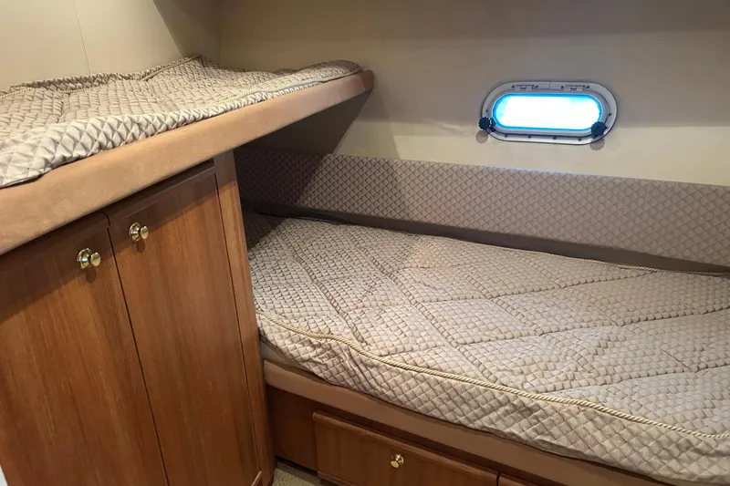 Slide: The Image of 1998 Bayliner 5788 Pilot House Motoryacht docked, featuring spacious deck and marina view. - 67