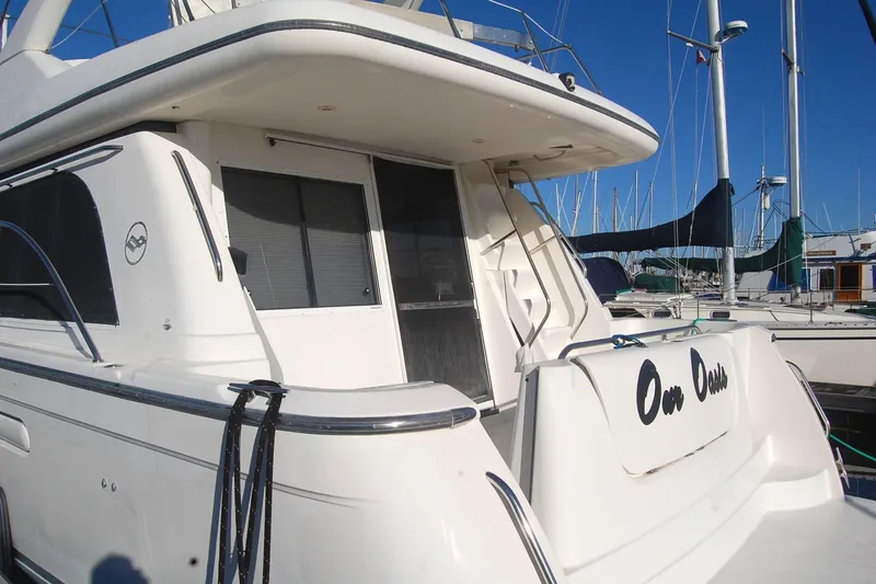 Slide: The Image of 1998 Bayliner 5788 Pilot House Motoryacht anchor detail against calm water. - 68