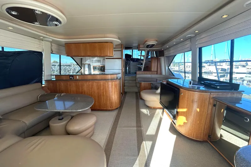 Slide: The Image of Luxurious interior of a 1998 Bayliner 5788 Pilot House Motoryacht with elegant wood finishes. - 7