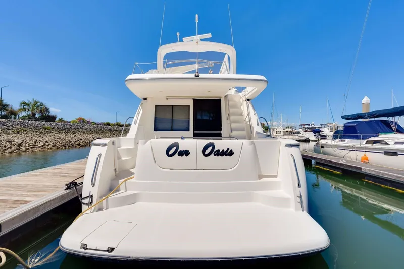 Slide: The Image of 1998 Bayliner 5788 Pilot House Motoryacht docked at marina under clear blue sky. - 84