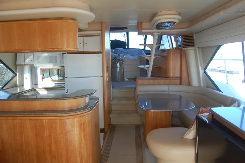 Slide: The Image of Luxurious interior of 1998 Bayliner 5788 Pilot House Motoryacht with modern kitchen and seating area. - 9