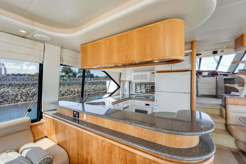 Slide: The Image of Luxurious interior of 1998 Bayliner 5788 Pilot House Motoryacht with modern kitchen amenities. - 92