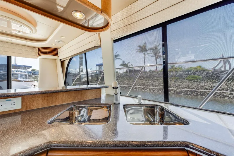 Slide: The Image of Luxurious kitchen interior of 1998 Bayliner 5788 Pilot House Motoryacht with dual sinks and scenic view. - 95
