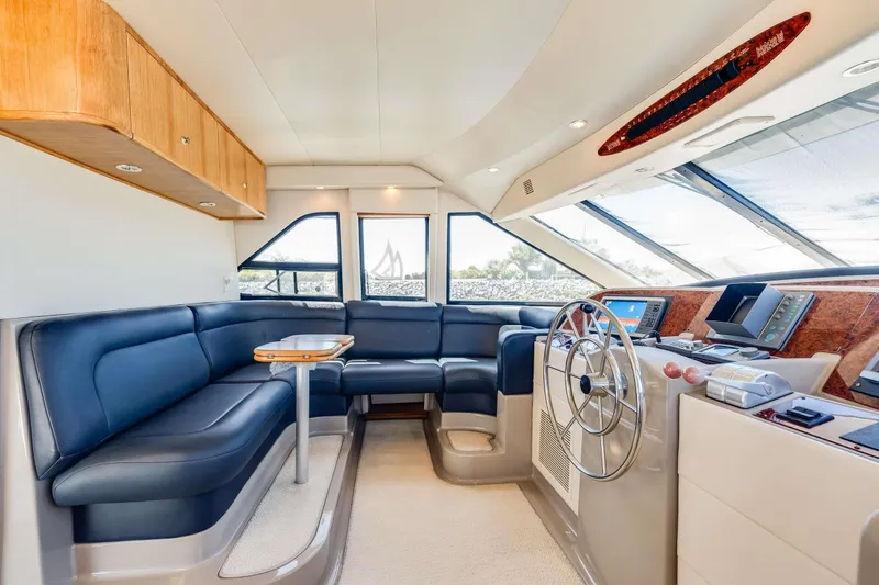 Slide: The Image of Luxurious interior of 1998 Bayliner 5788 Pilot House Motoryacht with plush seating and modern helm. - 98