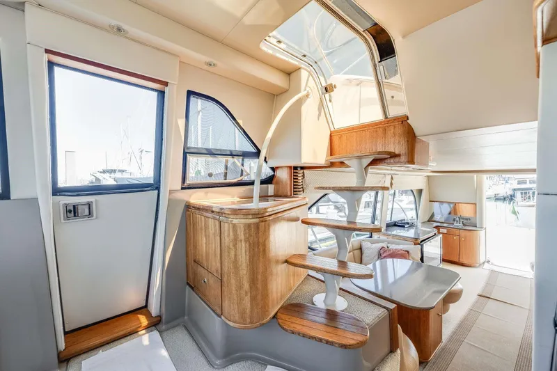 Slide: The Image of Luxurious interior of 1998 Bayliner 5788 Pilot House Motoryacht with modern design and wooden accents. - 99
