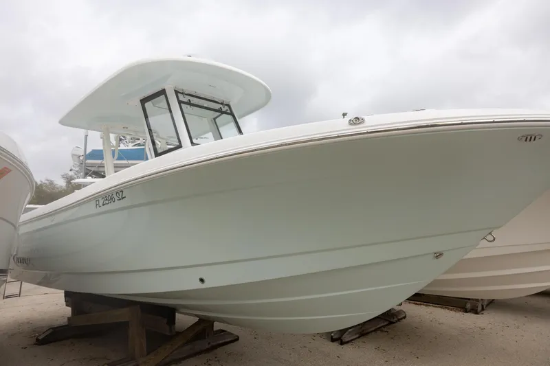 The Image of 2021 Robalo R272 Center Console boat on display, side view, cloudy sky background. - 0
