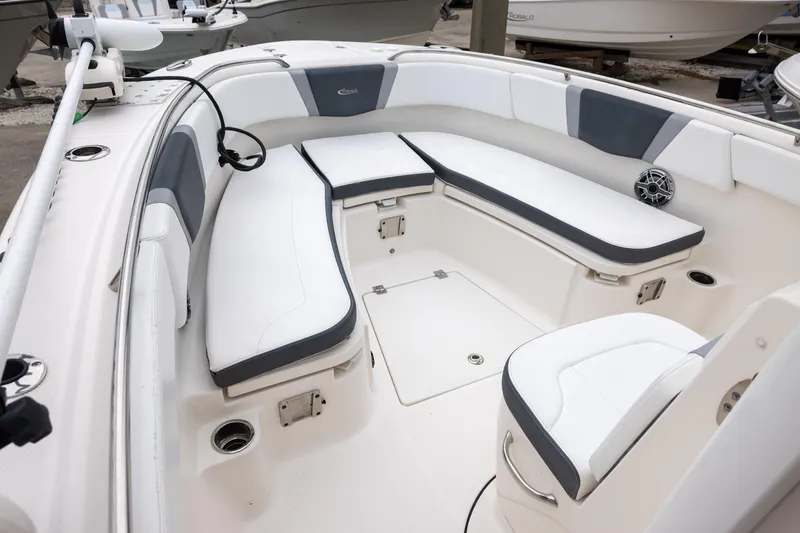 Slide: The Image of 2021 Robalo R272 Center Console boat interior with white cushioned seating. - 14