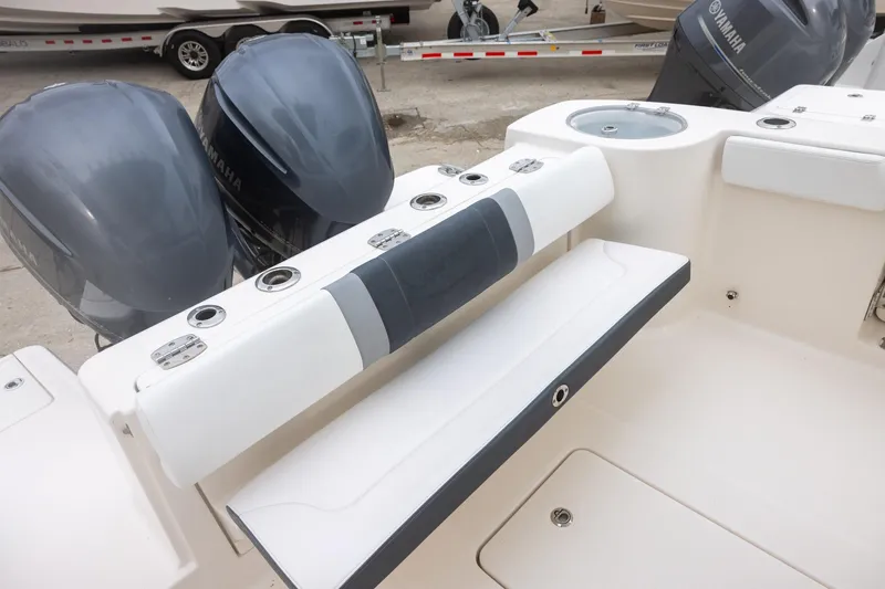 Slide: The Image of 2021 Robalo R272 Center Console boat with Yamaha engines and seating area. - 5