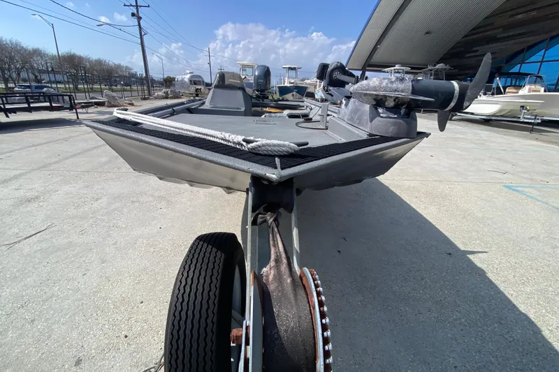 Slide: The Image of 1996 War Eagle 761 Renegade boat on trailer, outdoor setting, clear sky background. - 10