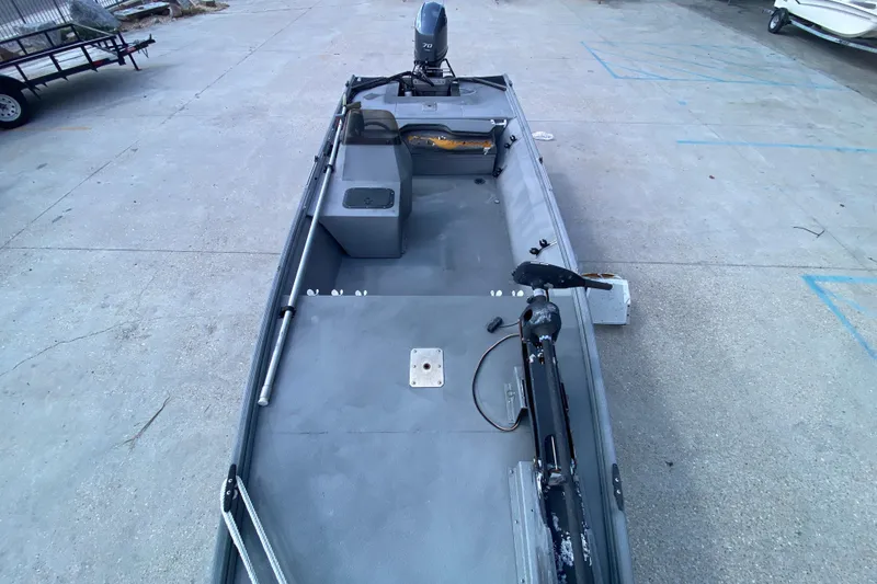 Slide: The Image of 1996 War Eagle 761 Renegade boat with motor, parked on concrete surface. - 12
